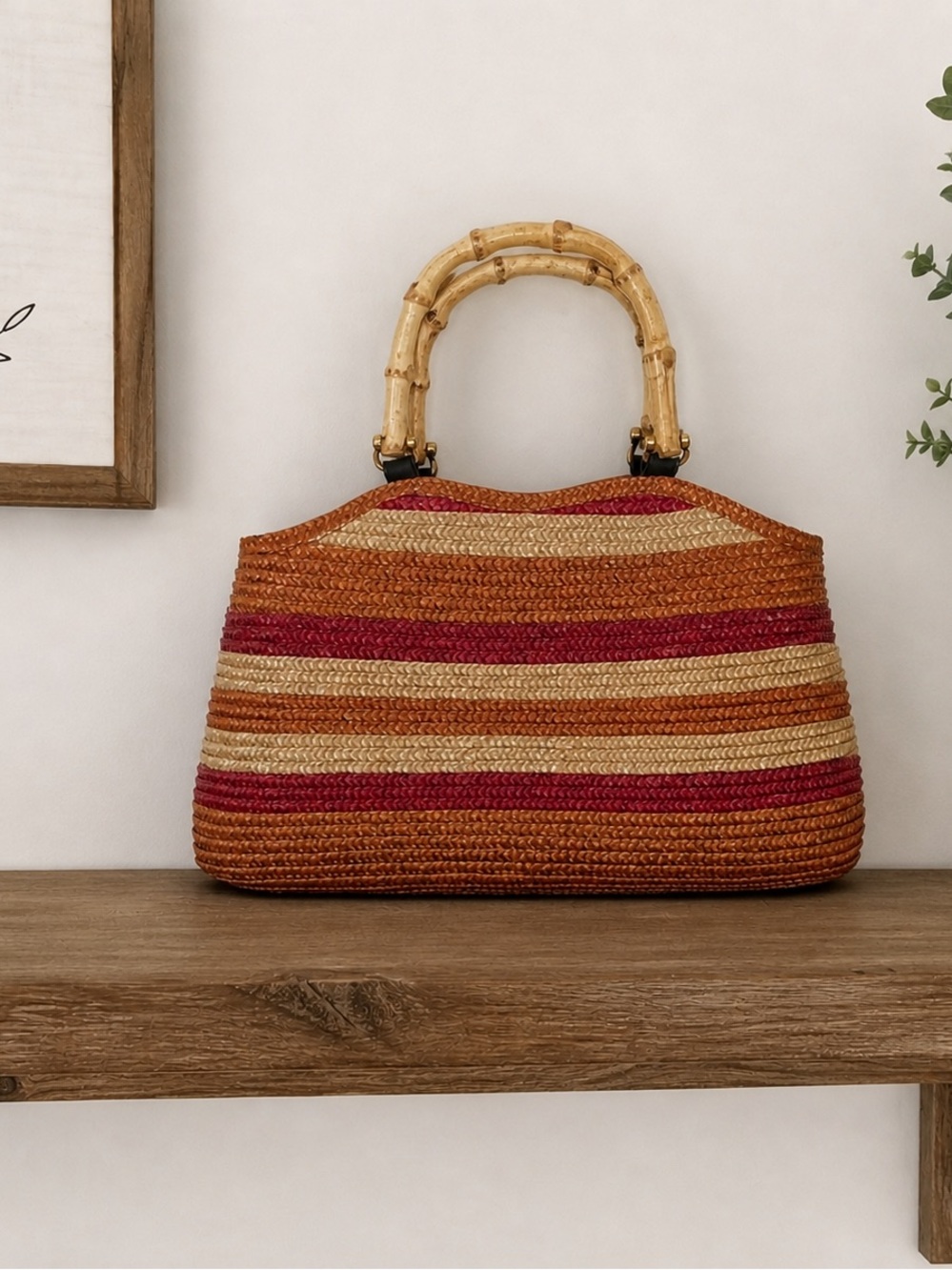 Gorgeous straw purse w/ bamboo handles. Snap closure and several inner pockets